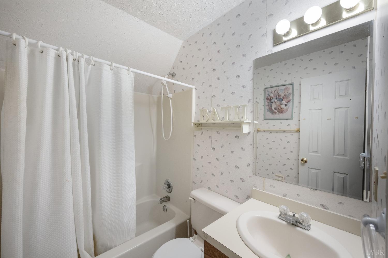 29 Dunivan Drive Rustburg, VA 24588 - Photo 48 of 61 a bathroom with a sink a toilet and shower curtain