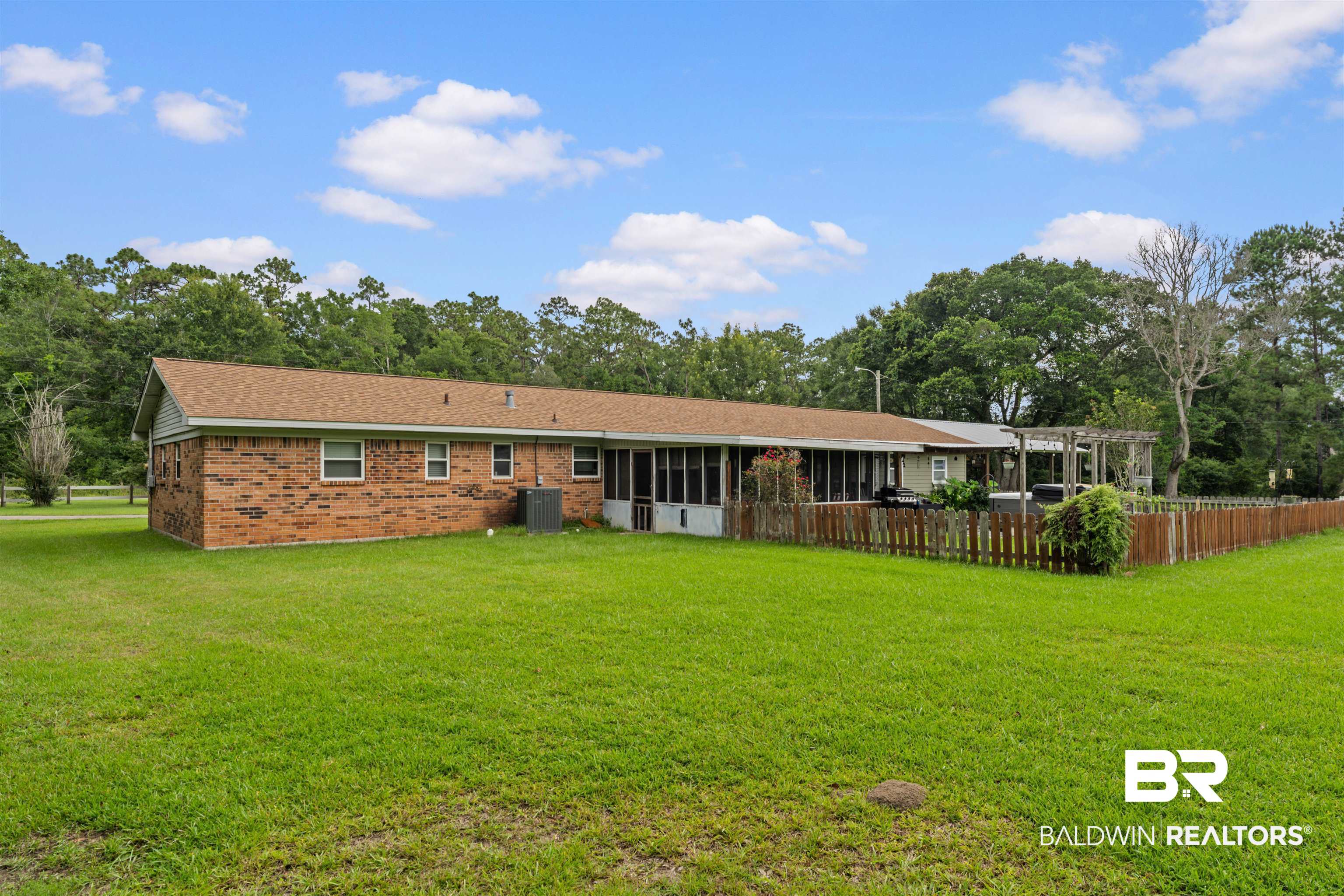 32794 Antietam Road Lillian, AL 36549 - Photo 2 of 20 Rear view of house featuring a sunroom, a pergola, and brick siding