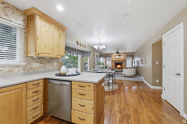 1888 East Cobblestone Road Springville, UT 84663 - Photo 18 of 44 Kitchen featuring wood cabinetry, light-toned countertops, and a mosaic tile backsplash