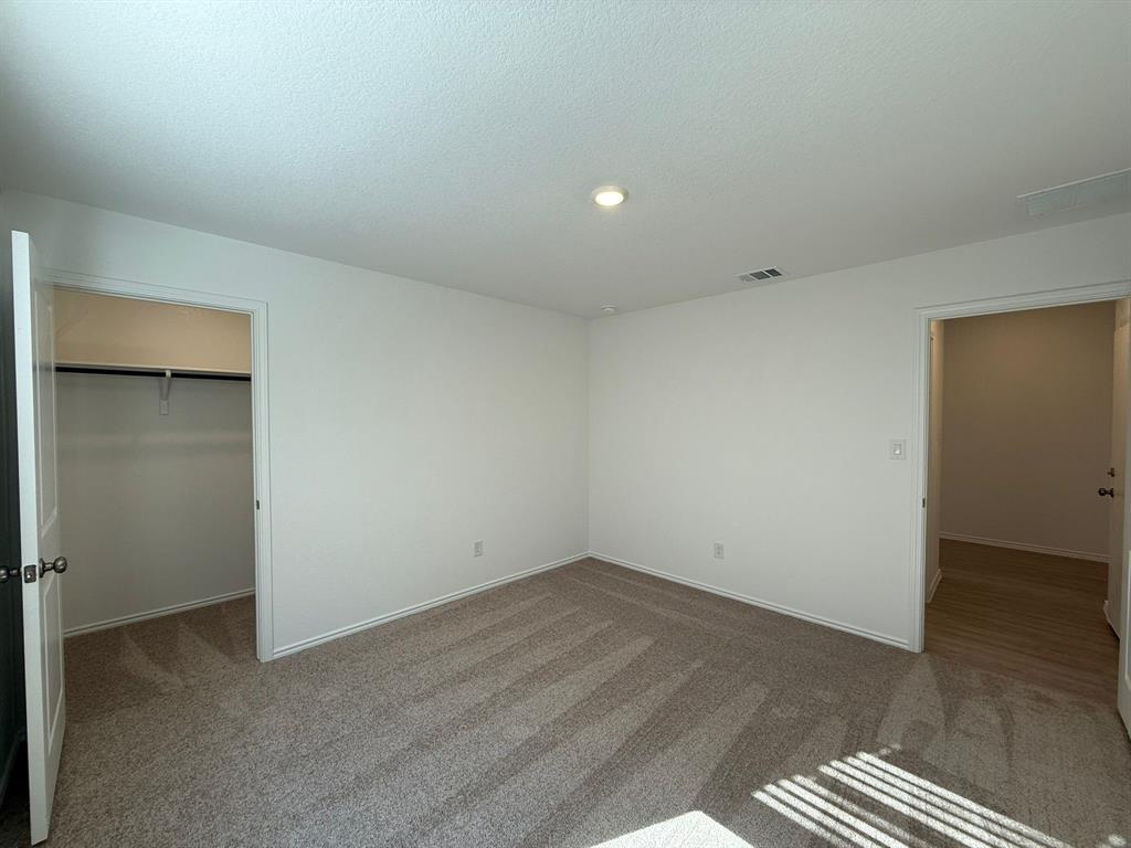 263 Magalia Lane Kyle, TX 78640 - Photo 11 of 37 an empty room with wooden floor