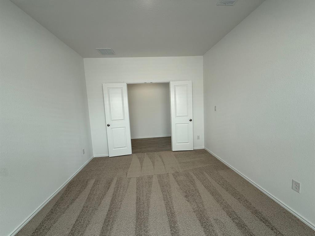 263 Magalia Lane Kyle, TX 78640 - Photo 13 of 37 a view of an empty room with wooden floor