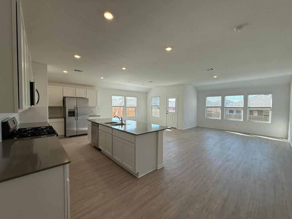 263 Magalia Lane Kyle, TX 78640 - Photo 23 of 37 a kitchen with stainless steel appliances granite countertop a stove and a refrigerator