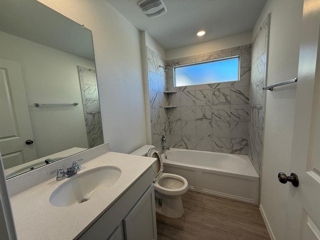 263 Magalia Lane Kyle, TX 78640 - Photo 7 of 37 a bathroom with a sink a toilet and shower