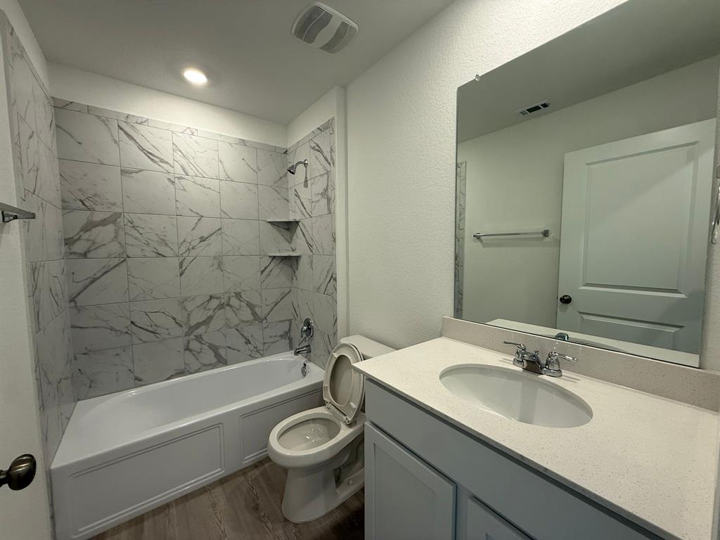 263 Magalia Lane Kyle, TX 78640 - Photo 9 of 37 a bathroom with a sink a toilet and bathtub