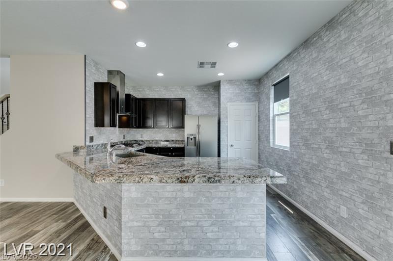 5475 Ordesa Valley Road Las Vegas, NV 89148 - Photo 25 of 35 Modern kitchen with granite countertops and stainless steel appliances.