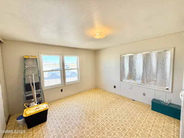 a spacious bedroom with a bed and a window