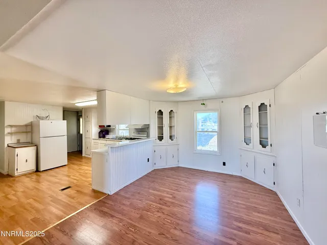 a large white kitchen with cabinets