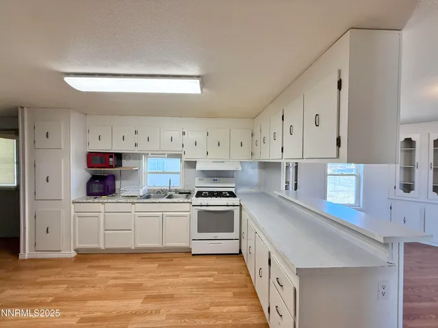 a kitchen with stainless steel appliances granite countertop a stove and a sink