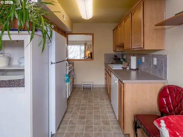 a kitchen with a sink a refrigerator and a stove