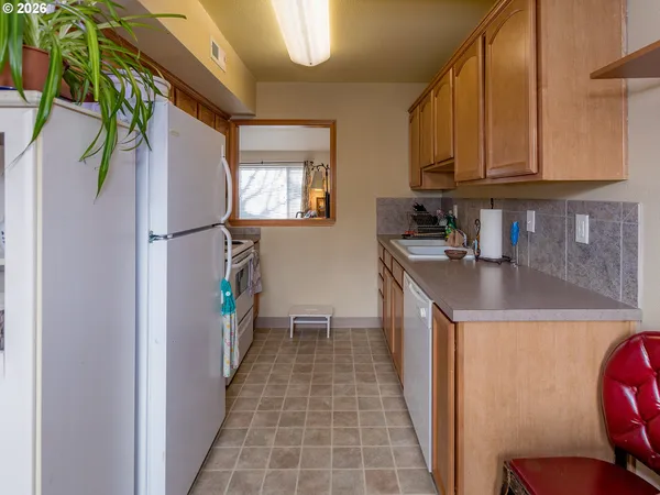 a kitchen with a refrigerator a stove and a sink
