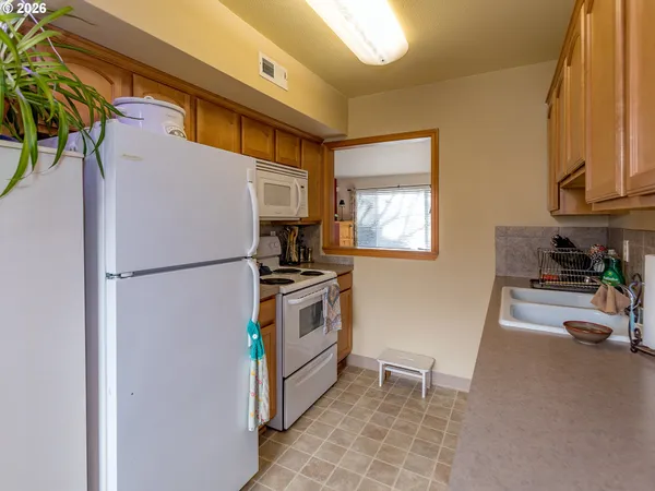 a kitchen with stainless steel appliances granite countertop a sink a microwave cabinets and a dining table