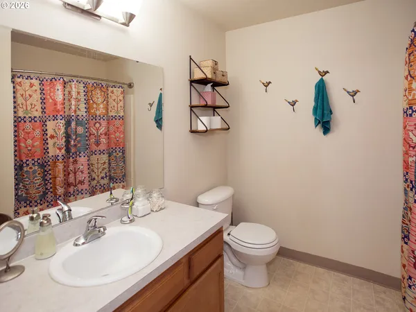 a spacious bedroom with a bed and a chandelier