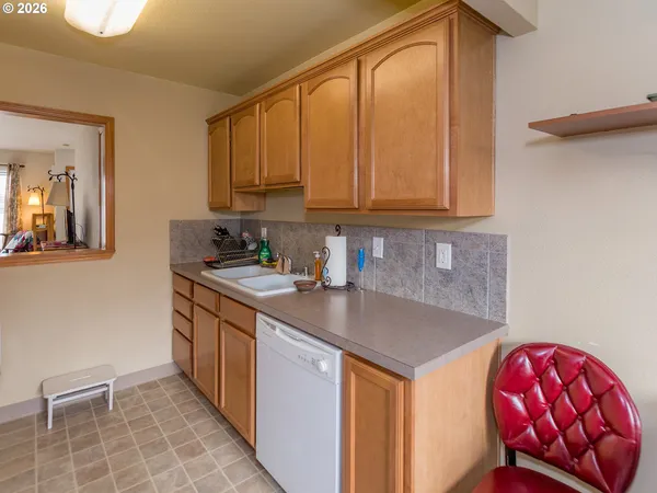 a kitchen with stainless steel appliances granite countertop a sink a microwave cabinets and a dining table