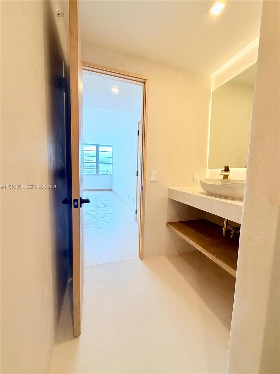 100 Lincoln Road, Unit 1241 Miami Beach, FL 33139 - Photo 15 of 18 a bathroom with a double vanity sink a mirror and a bathtub