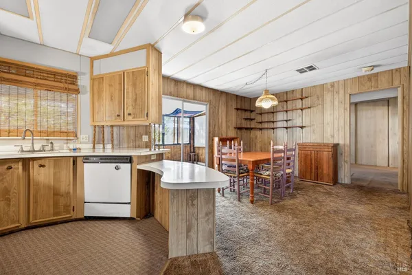 a large kitchen with a table and chairs