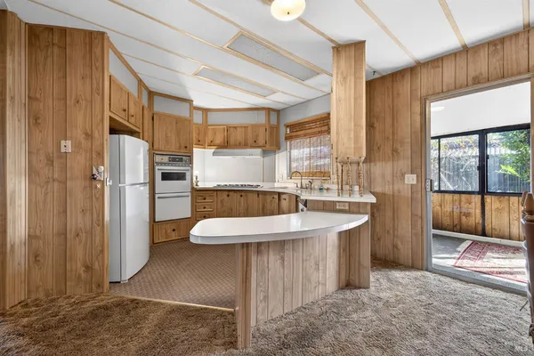 a kitchen with granite countertop a sink stainless steel appliances and cabinets