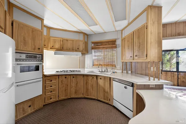 a dining room with furniture and a floor to ceiling window
