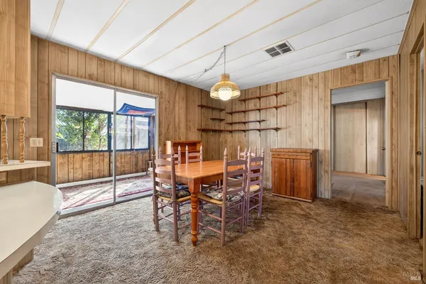 a view of washer and dryer with kitchen in the background