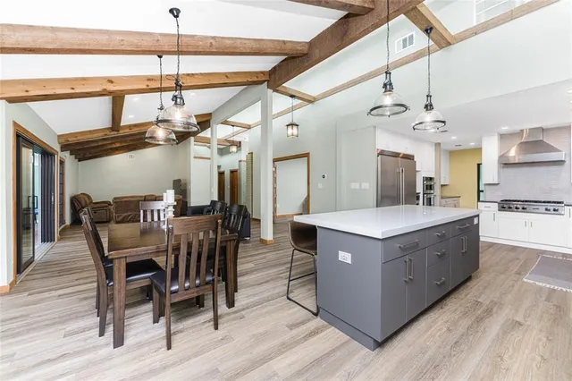 a kitchen with stainless steel appliances granite countertop a sink a stove and a refrigerator