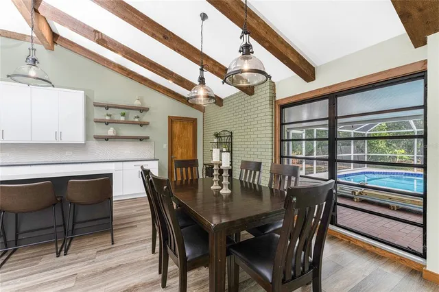 a kitchen with stainless steel appliances granite countertop a lot of counter space and wooden floors