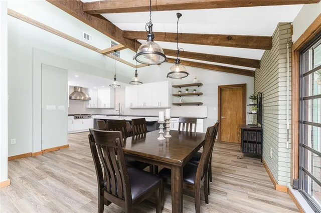 a kitchen with granite countertop a sink and a stove top oven