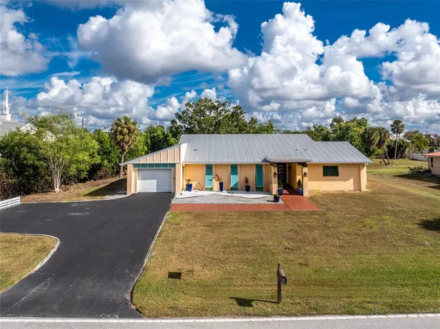 a view of a hallway with wooden floor and a potted plant