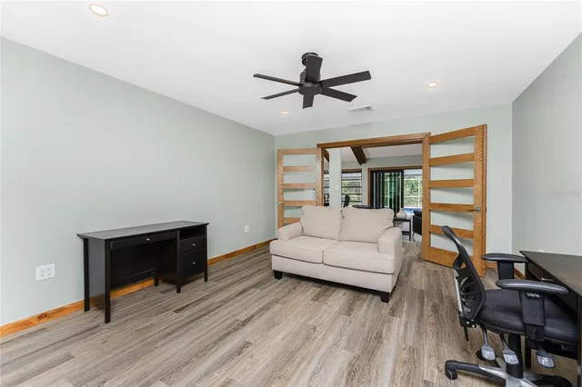 a bedroom with a bed and a flat tv screen on dresser