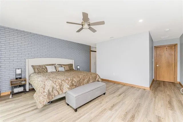 a view of a hallway with wooden floor and a living room