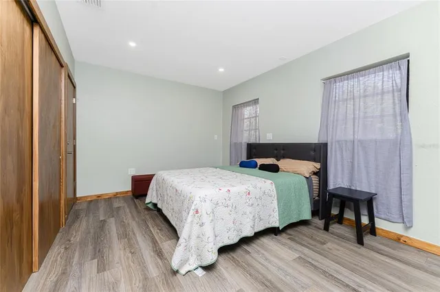 a view of a house with a yard and potted plants