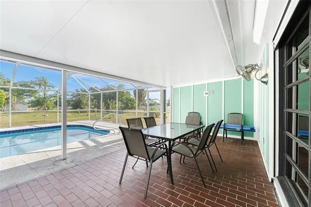 an aerial view of residential houses with outdoor space and swimming pool