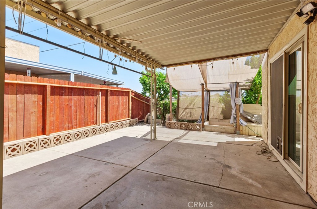 29368 Murrieta Road Menifee, CA 92586 - Photo 16 of 20 a backyard with table and chairs and potted plants