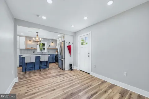 a view of a bedroom with wooden floor and a window