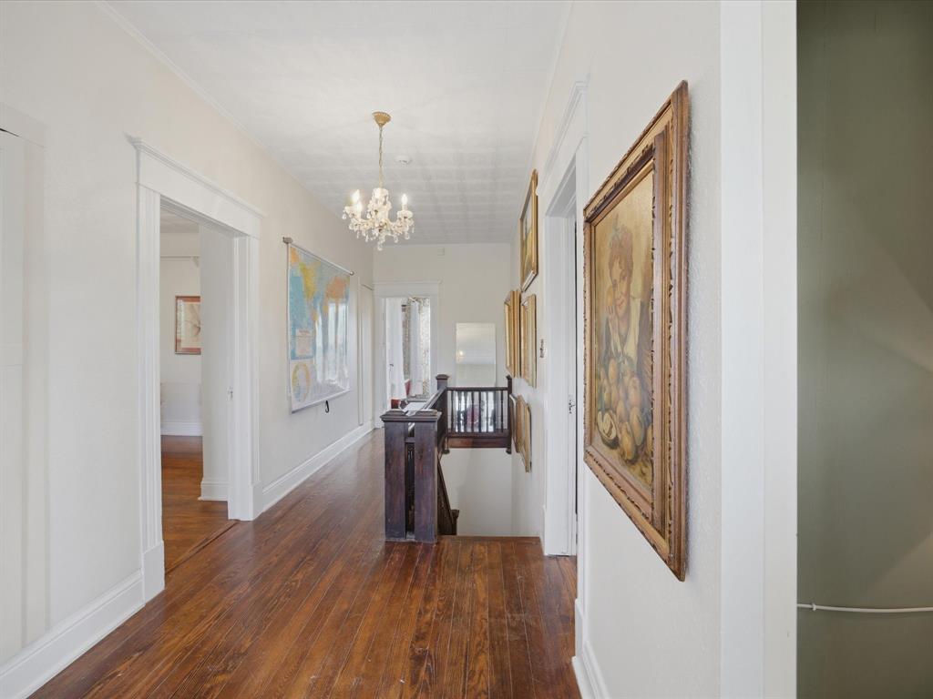 907 4th Street Graham, TX 76450 - Photo 18 of 34 a very nice looking room with wooden floor and a chandelier