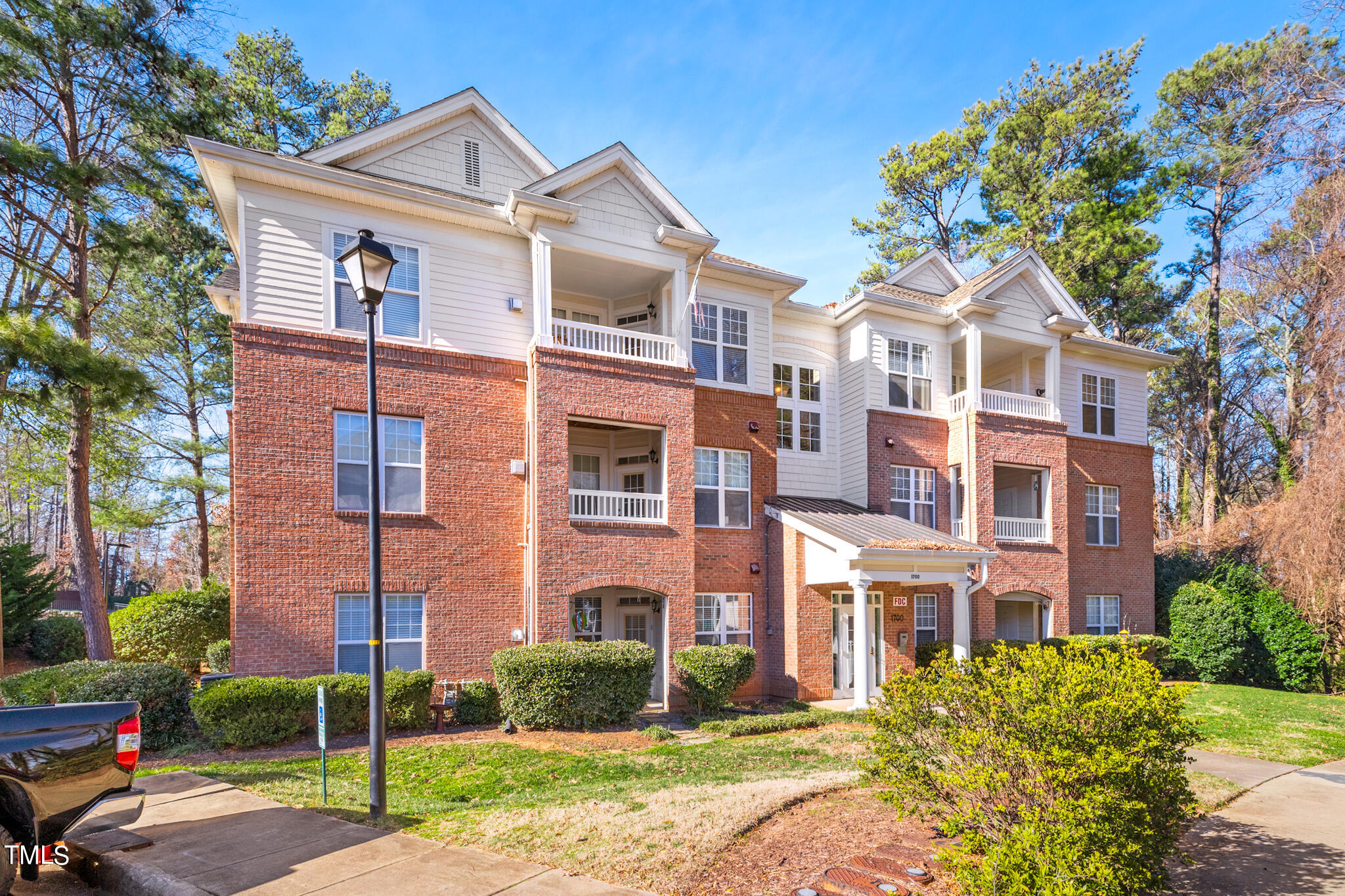 1700 Tiffany Bay Court, Unit 303 Raleigh, NC 27609 - Photo 1 of 30 a front view of a house with garden