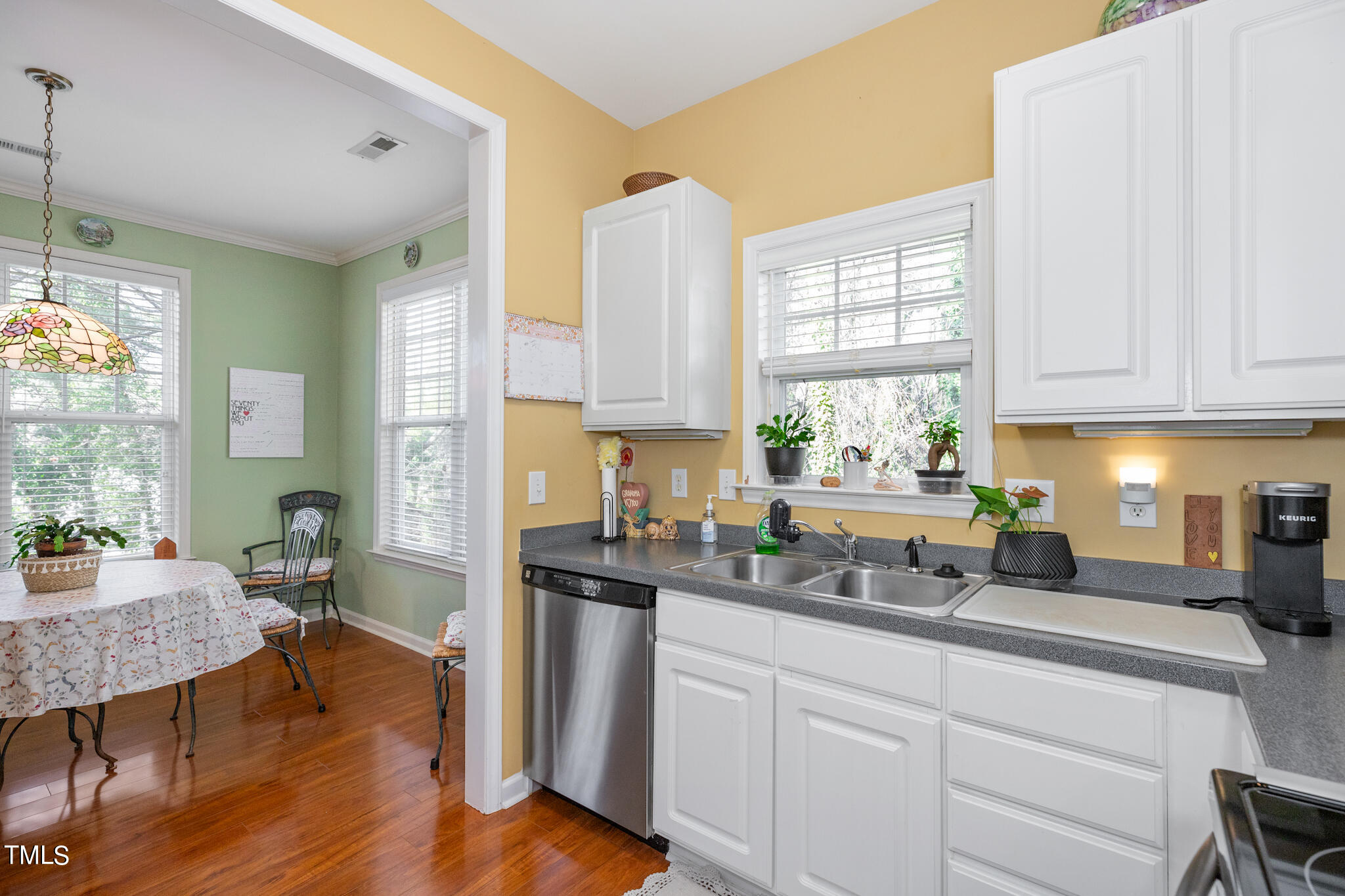 1700 Tiffany Bay Court, Unit 303 Raleigh, NC 27609 - Photo 16 of 30 a kitchen with a window a sink and cabinets