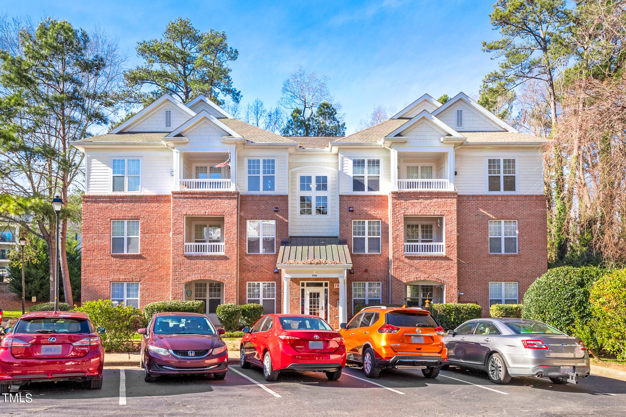 1700 Tiffany Bay Court, Unit 303 Raleigh, NC 27609 - Photo 2 of 30 a cars parked in front of a brick house