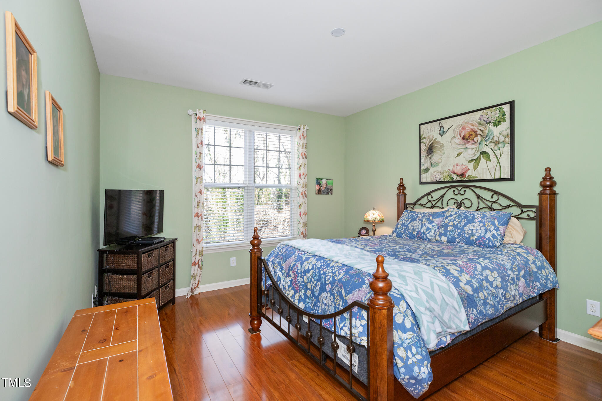 1700 Tiffany Bay Court, Unit 303 Raleigh, NC 27609 - Photo 24 of 30 a bedroom with a bed and a flat screen tv