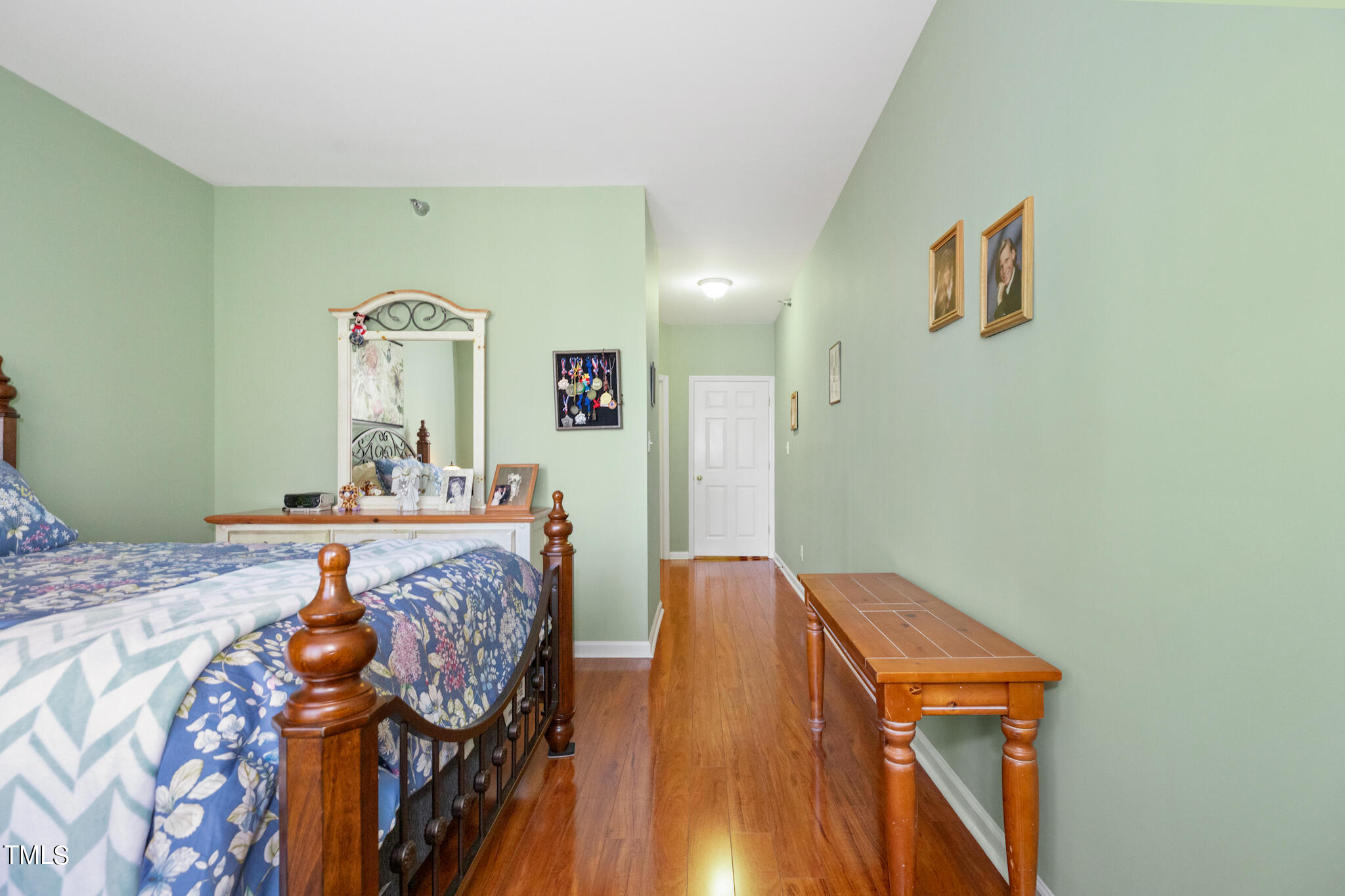 1700 Tiffany Bay Court, Unit 303 Raleigh, NC 27609 - Photo 25 of 30 a bed room with furniture and wooden floor