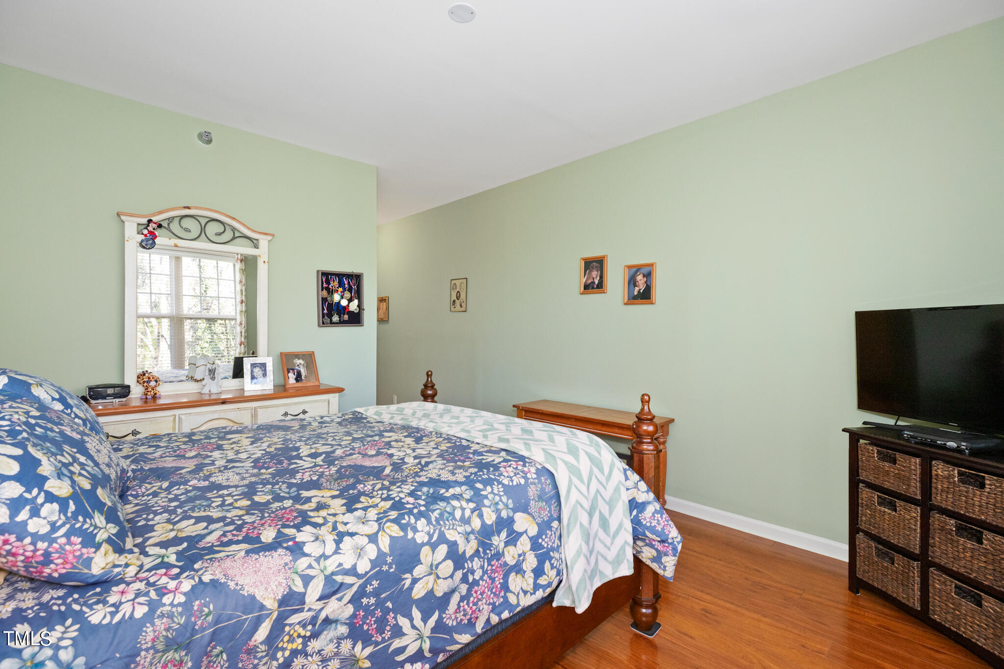 1700 Tiffany Bay Court, Unit 303 Raleigh, NC 27609 - Photo 26 of 30 a bedroom with a bed and a flat screen tv