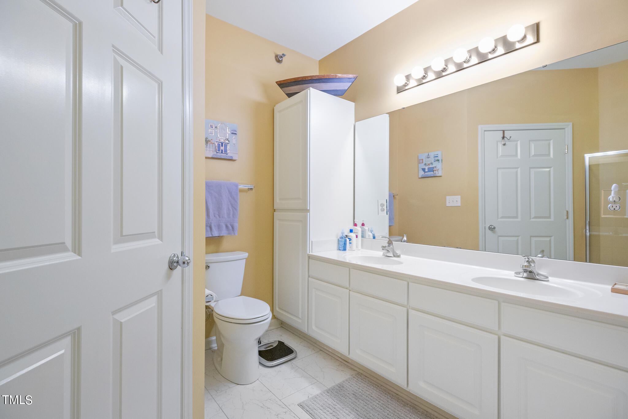 1700 Tiffany Bay Court, Unit 303 Raleigh, NC 27609 - Photo 29 of 30 a bathroom with a double vanity sink toilet and shower