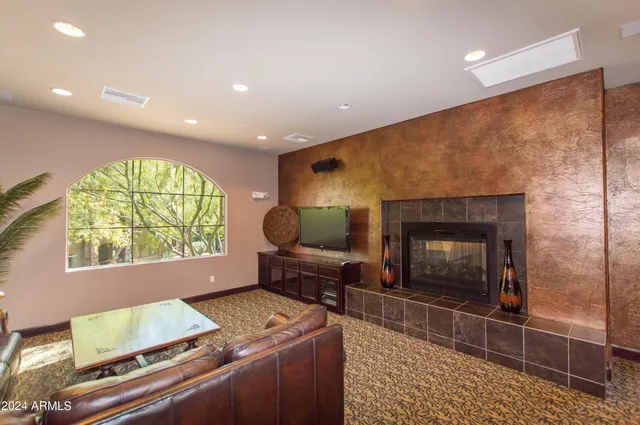 a living room with furniture a rug and a chandelier