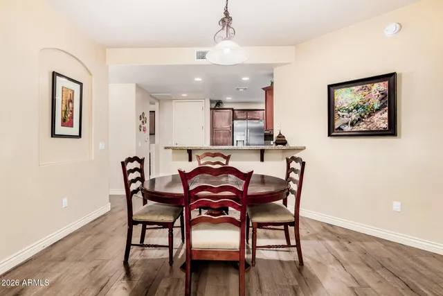 a view of a dining room with furniture and wooden floor