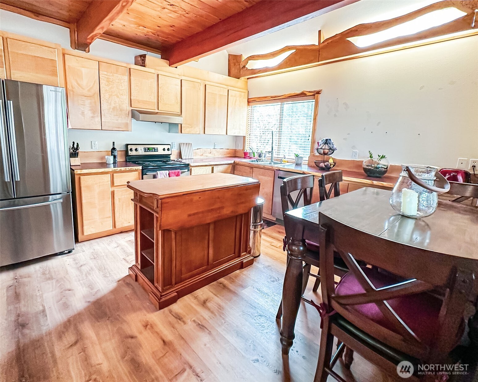132 Findley Road Morton, WA 98356 - Photo 3 of 28 a kitchen with a stove a refrigerator and a dining table with wooden floors
