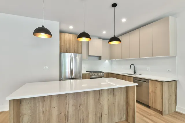 a kitchen with a sink a counter space cabinets and stainless steel appliances