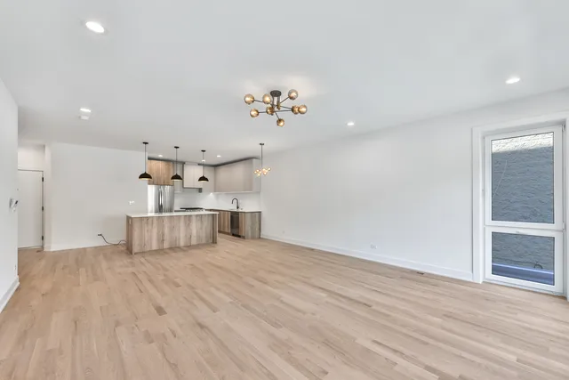 a view of a kitchen with wooden floor