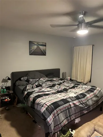 a bedroom with a bed and a night stand