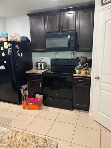 a kitchen with stainless steel appliances granite countertop a refrigerator stove and sink