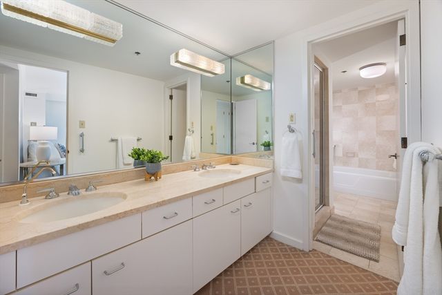 a spacious bathroom with a shower sink and mirror