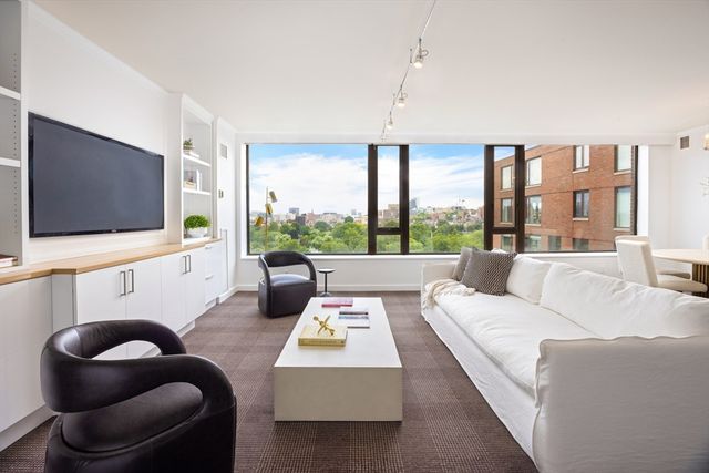 a living room with furniture large window and a flat screen tv