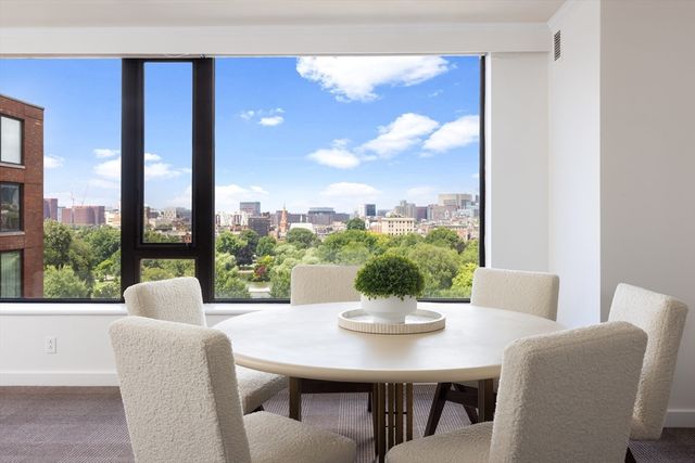 a dining room with furniture window and outside view